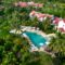 Stunning aerial shot of a resort with swimming pool and lush palm trees for a tropical getaway.